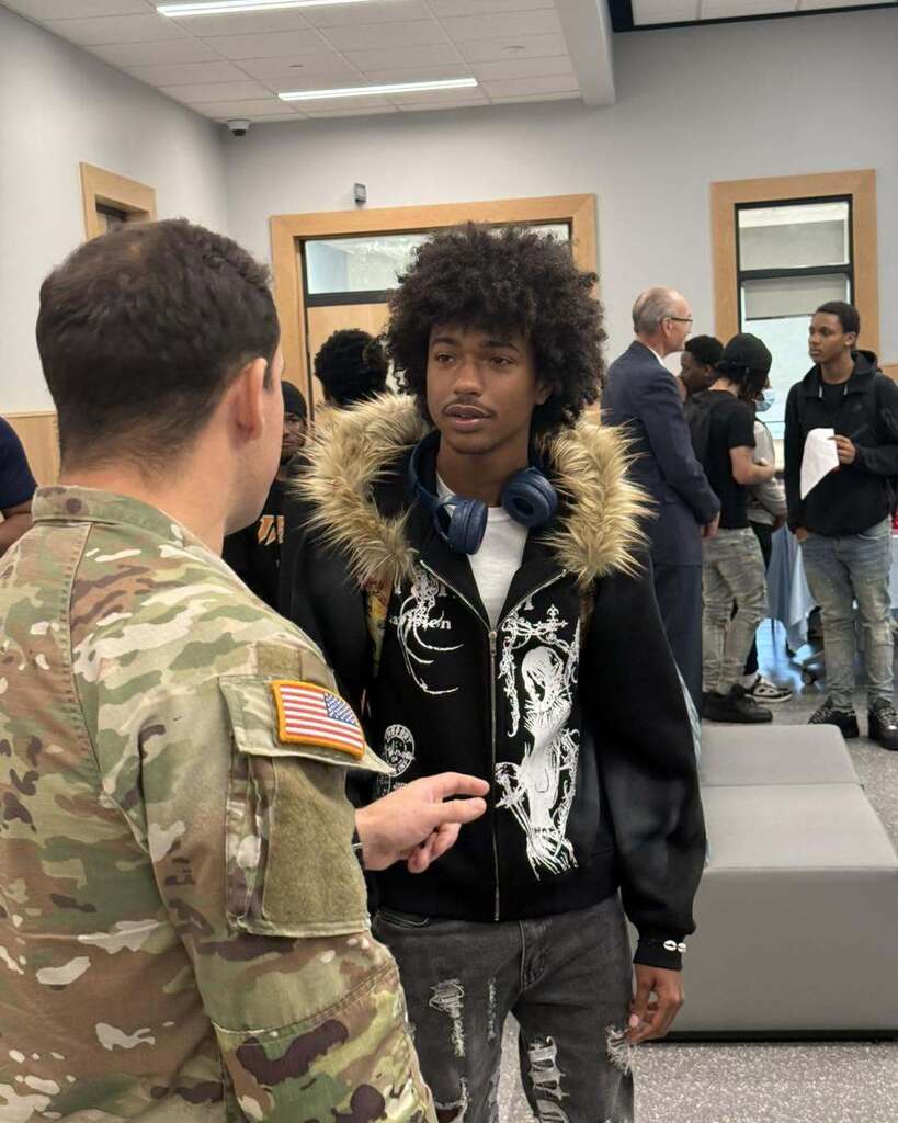 student interacting with community member during 100 Men Day Sept. 17, 2026