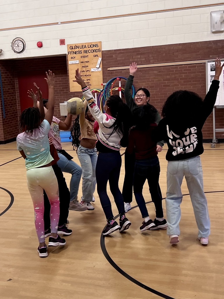 5th graders high five each other.