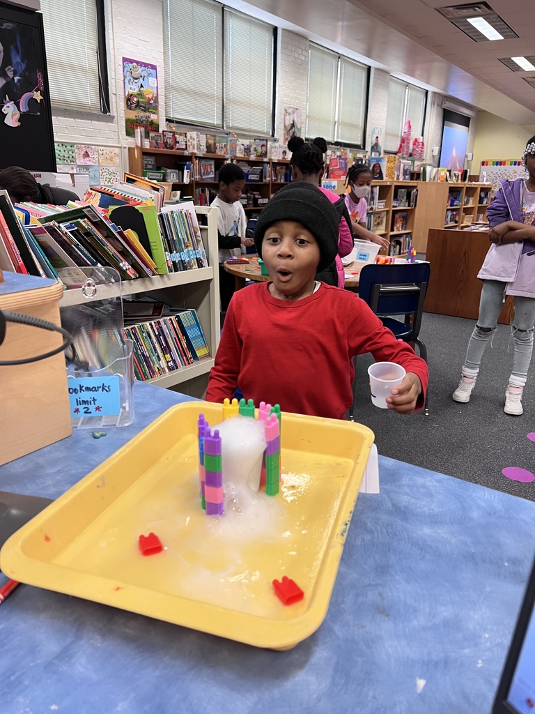 Student marvels over their baking soda explosion.