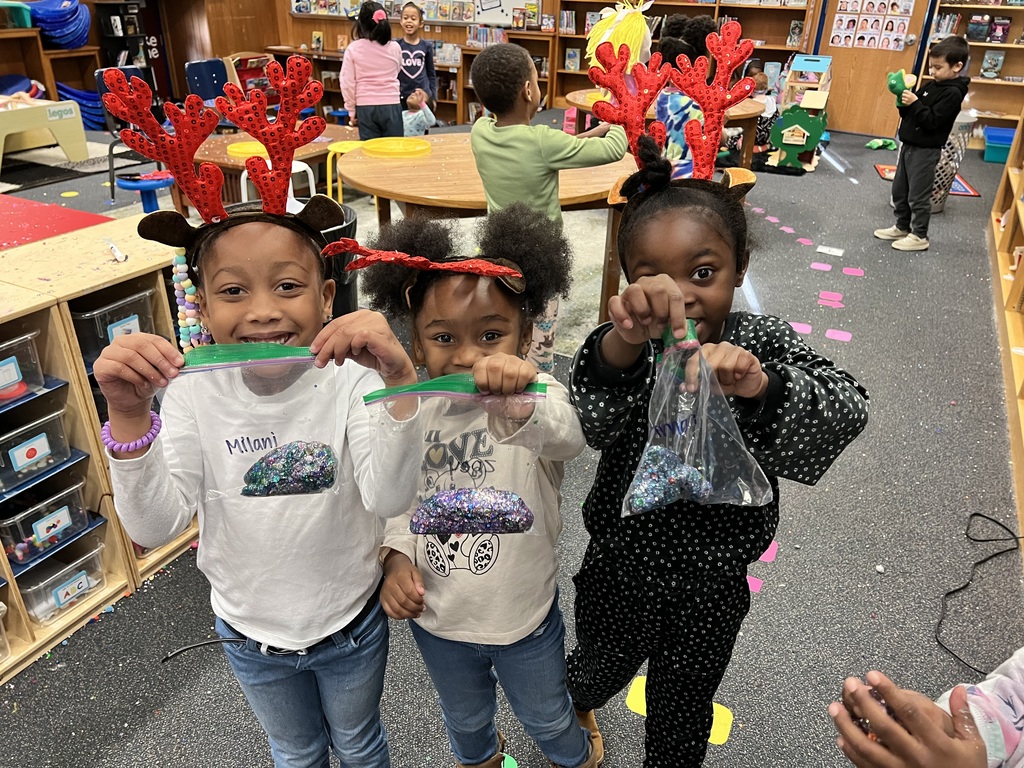 Kindergarteners pose with ziplocks of galaxy slime.