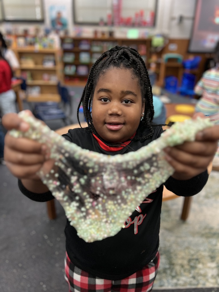A third grade student shows off their slime.