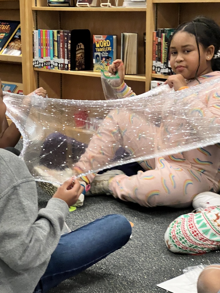 Fourth graders test their slime to see how far it can stretch.