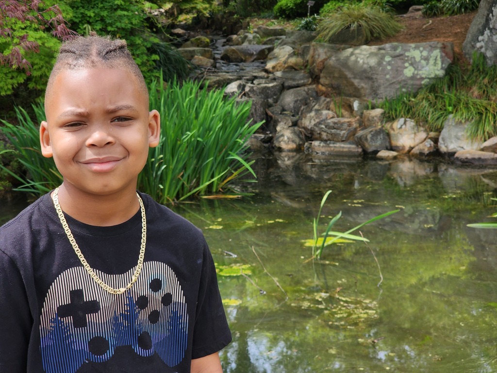 Student looks at the camera with the water behind them.