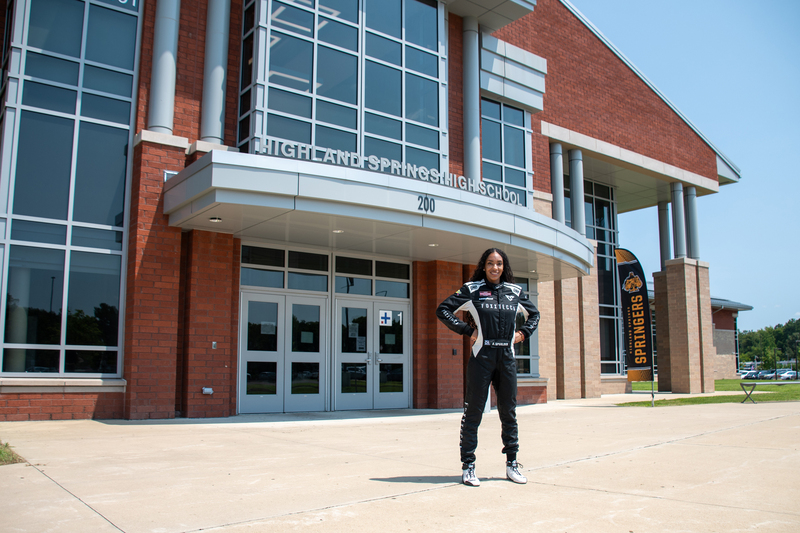 NASCAR Truck Series driver and Highland Springs High School graduate Dystany Spurlock poses in front of Highland Springs High School.