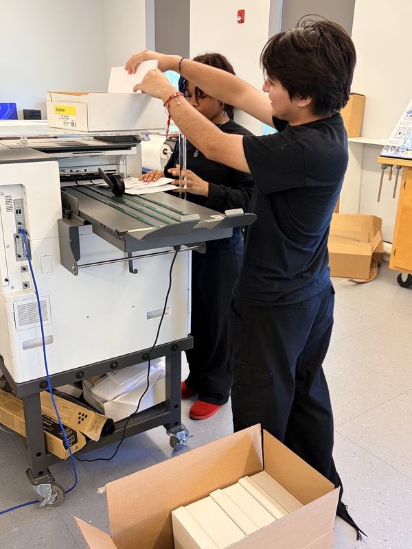 graphics studetns use the envelopes printing machine
