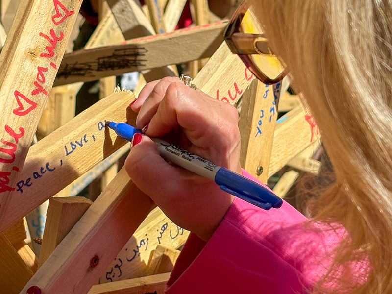 Godwin principal Leigh Dunavant signs a wooden sculpture.