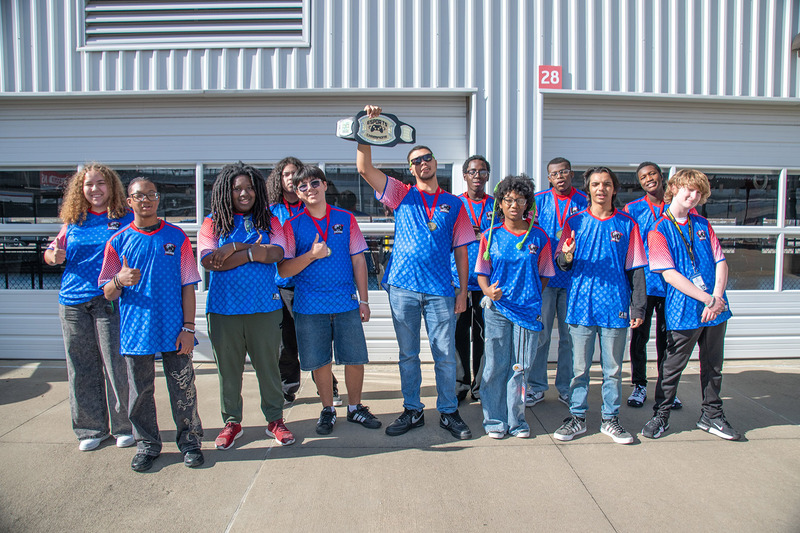 Hermitage High School won the Redline Super Smash Bros. Ultimate tournament. Jamie Keith holds up the  championship belt with his teammates who all received medals.