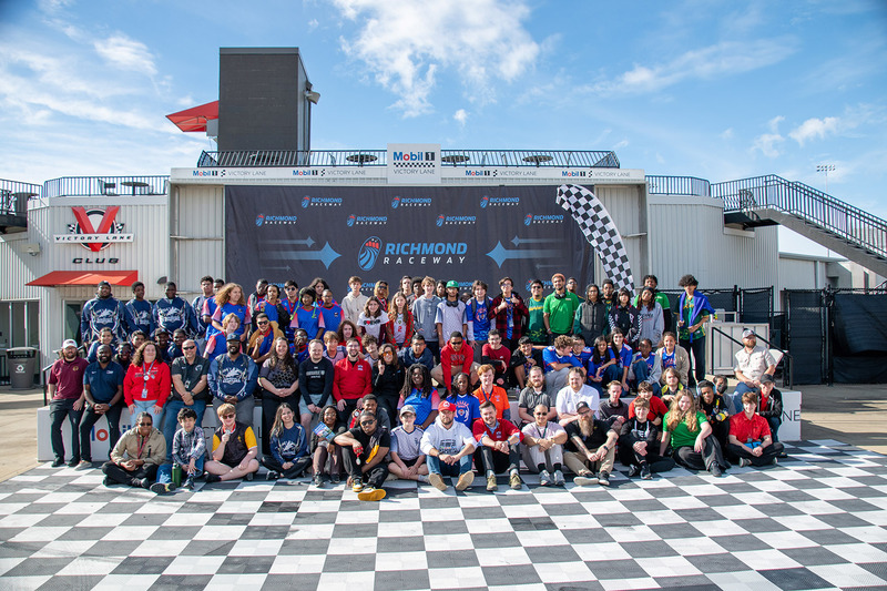All of the teams, their teacher-coaches and organizers gather in the winner’s circle at the end of the day.