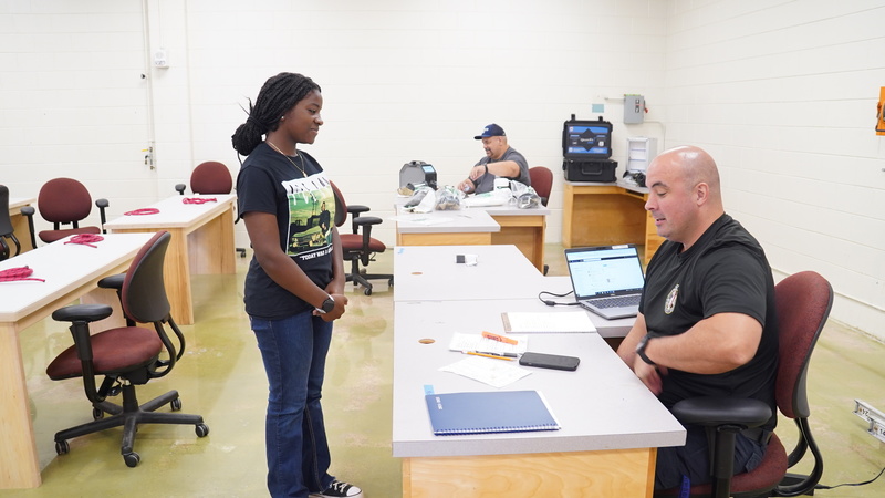 student talking to instructor.
