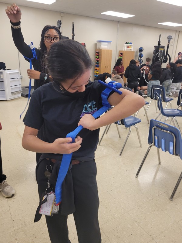 Student simulate a tourniquet application during a "Stop the Bleed Certification"