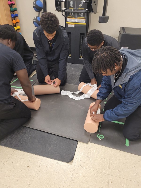 Student pack simulated wounds during a "Stop the Bleed Certification"