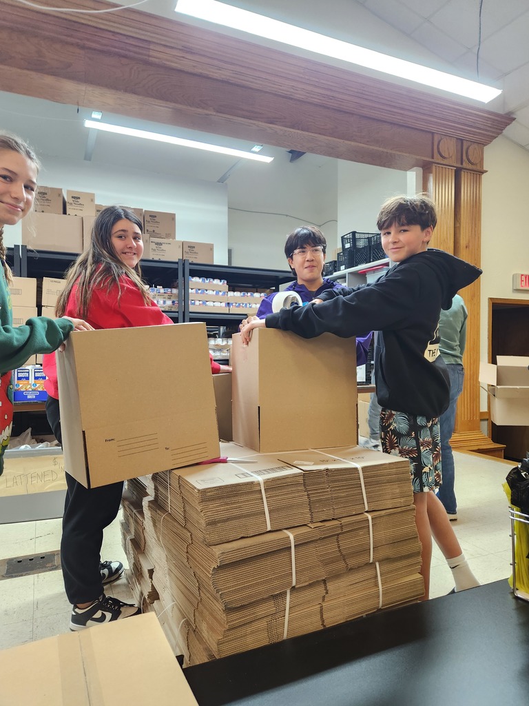 Students putting boxes and double sacks together for the food bank