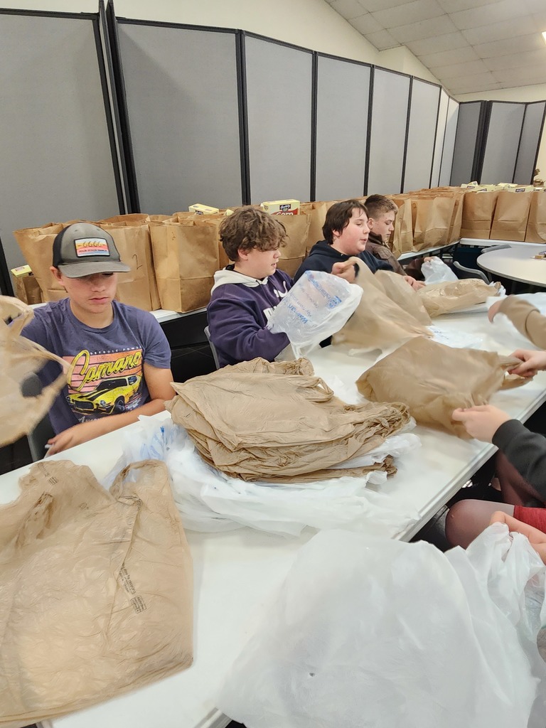 Students putting boxes and double sacks together for the food bank