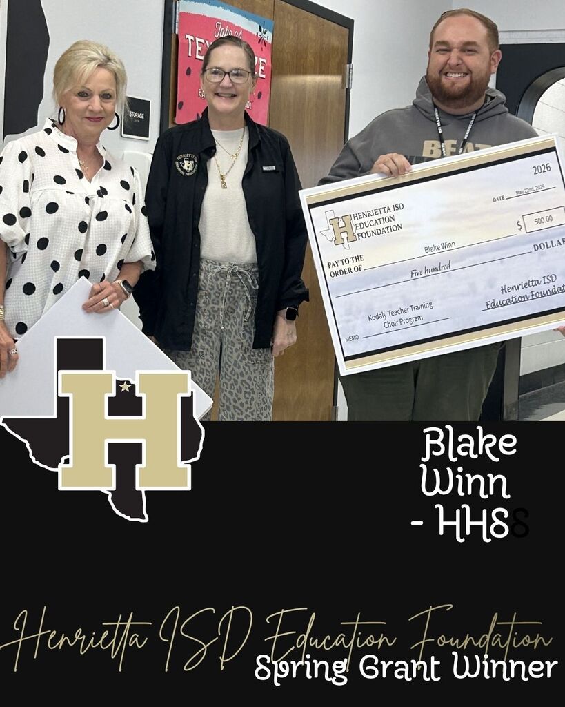 Three people stand with a large check, one holding a sign with "H" and the letters "H" and "W".