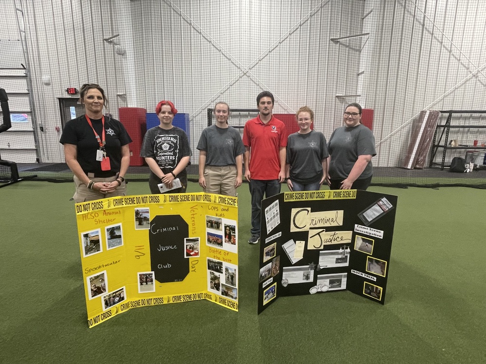 group of criminal justice club students with trifolds