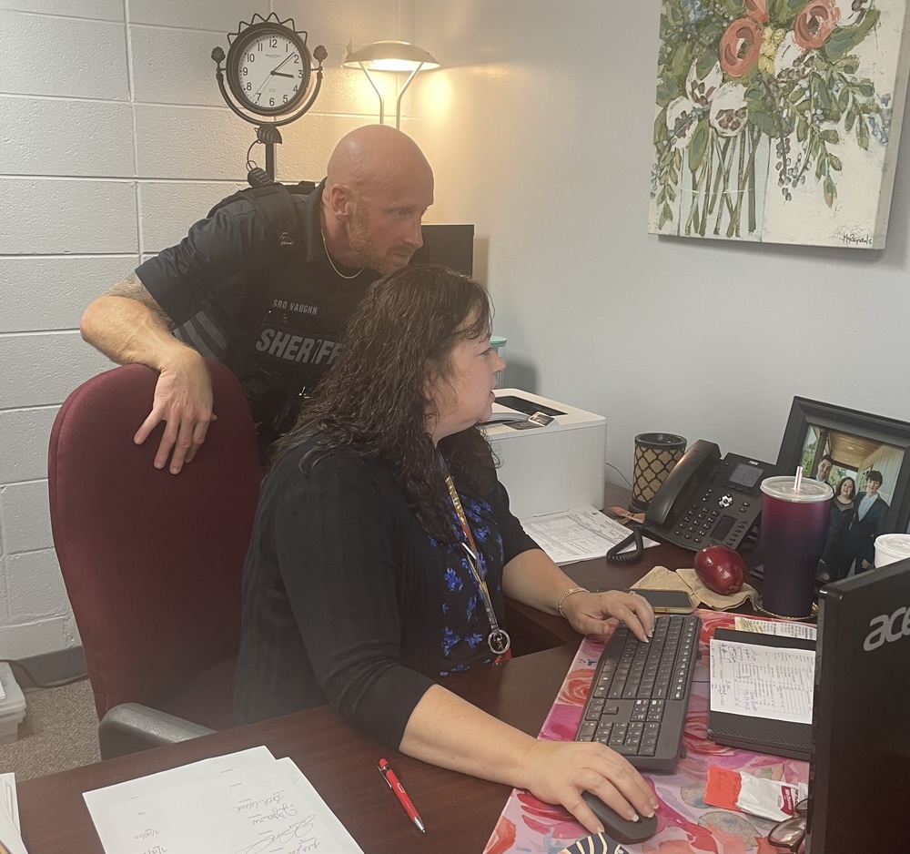 SRO and School Counselor look at computer screen