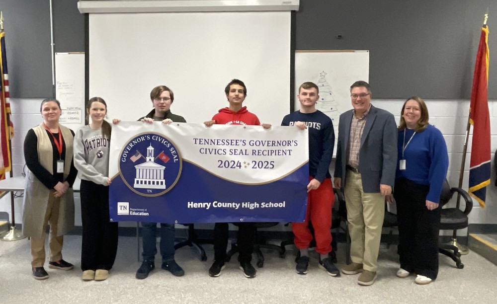 students and teachers hold banner