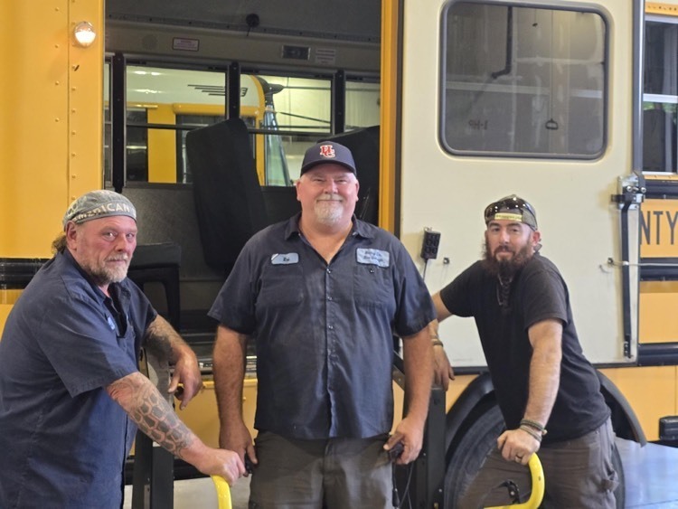 three bus technicians