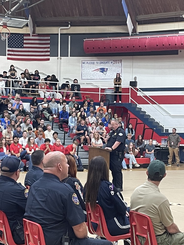 speaker in gym full of students
