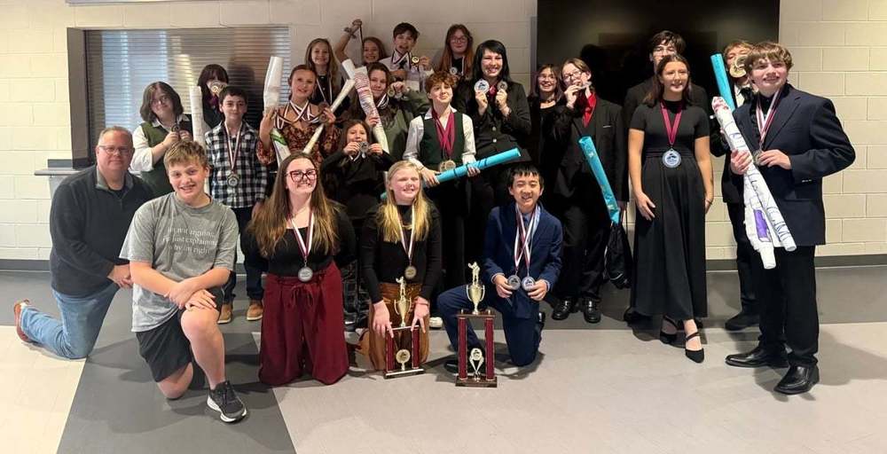 group of students with trophies