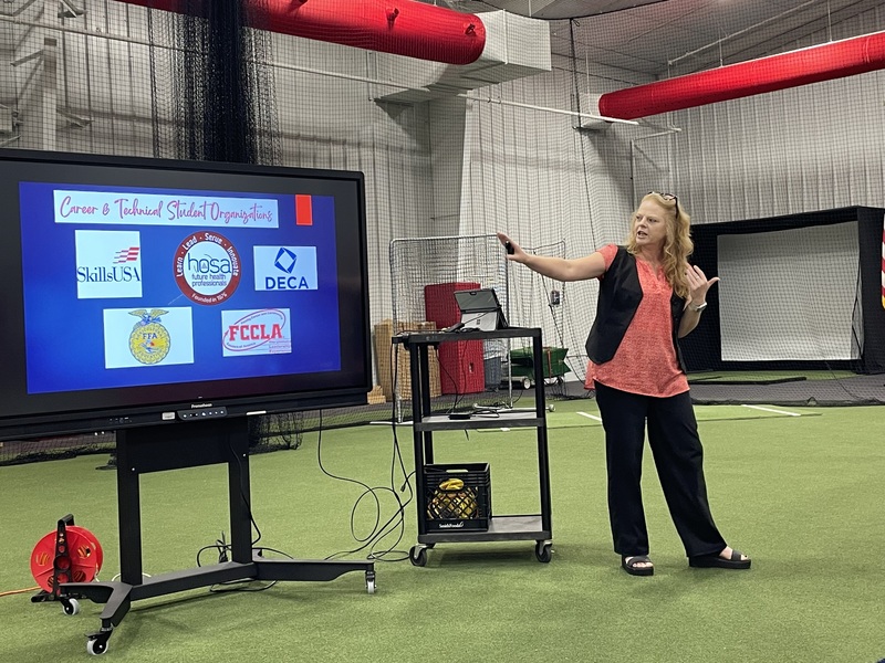 woman pointing to screen with CTE club logos