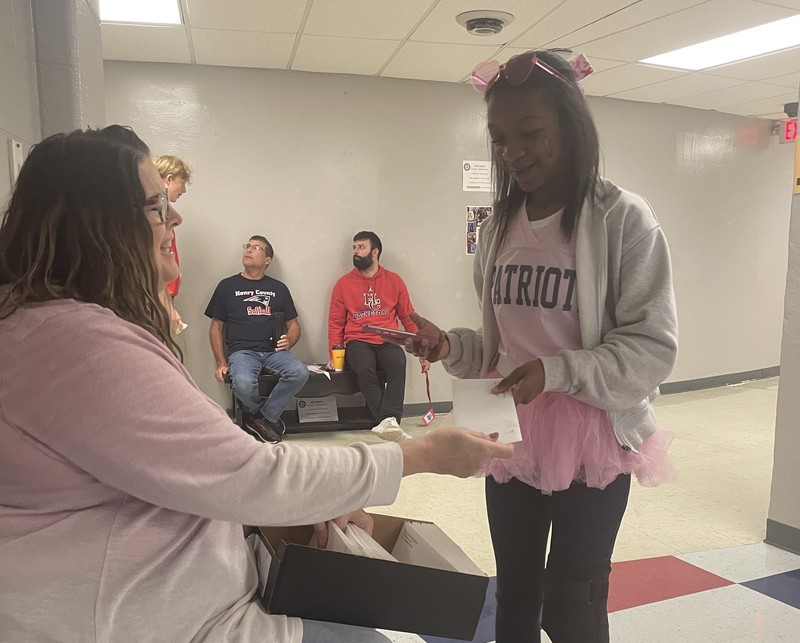 Teacher gives student an envelope