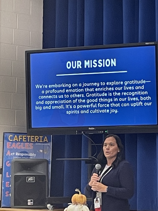 woman presenting an our mission slide