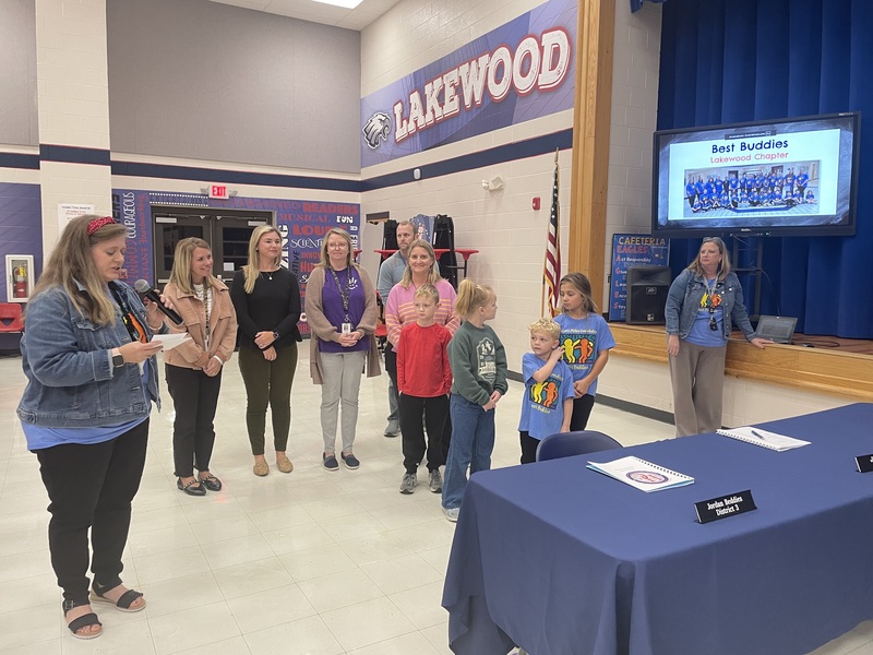 group of teachers and students present to board