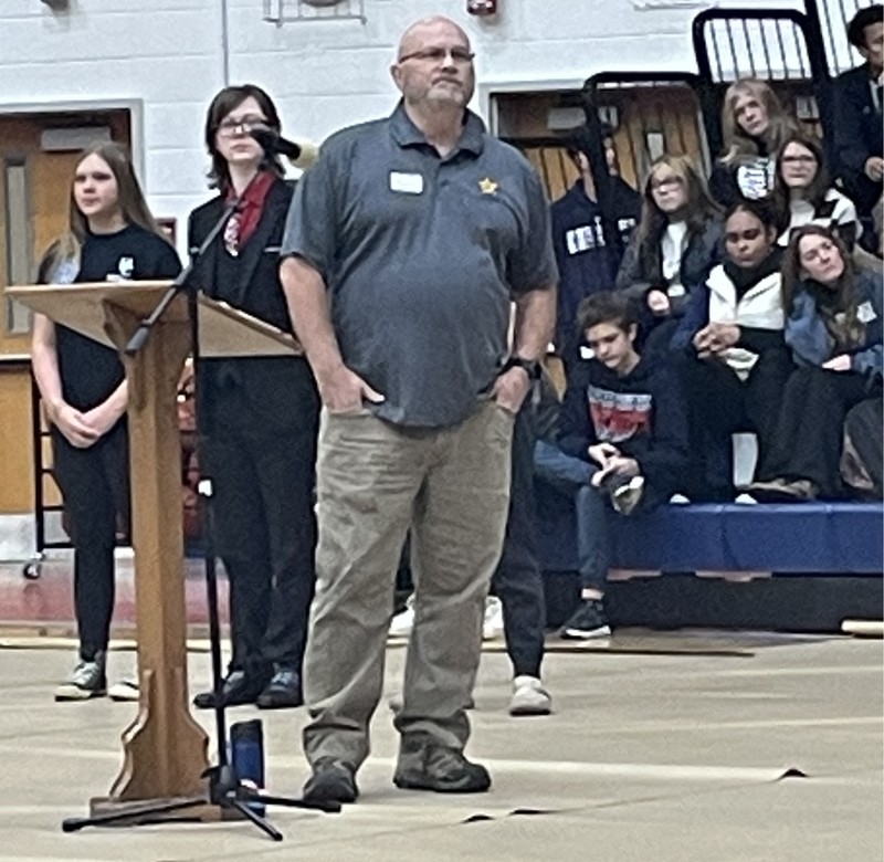 speaker in gym full of students