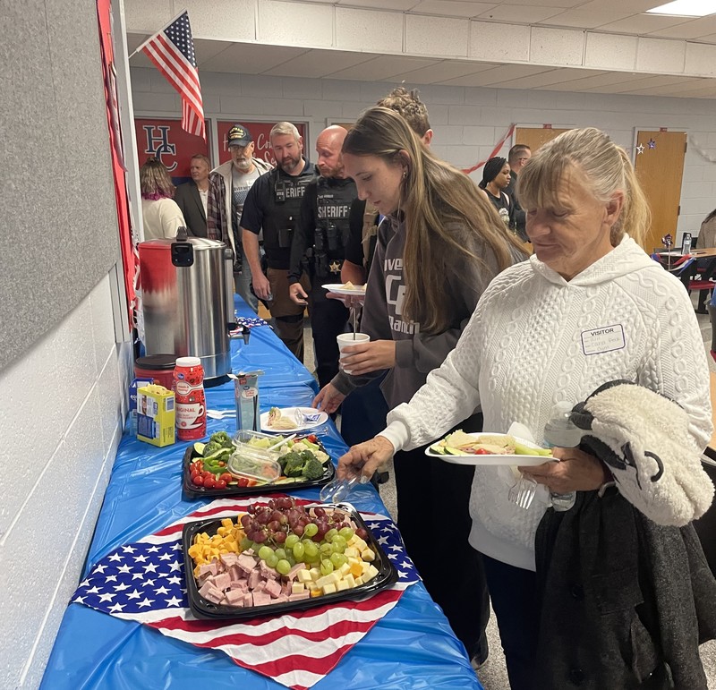 reception table with food and line of people