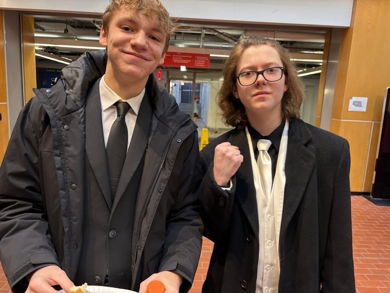 two male students standing in hallway
