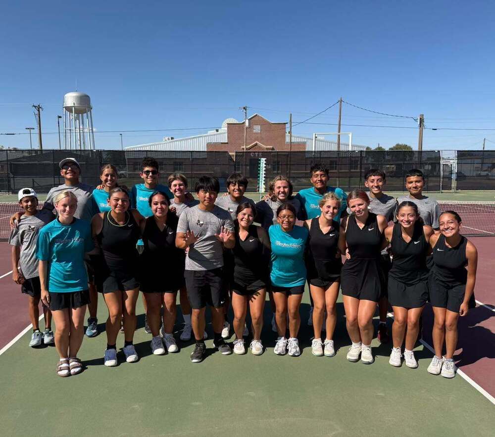 Herd Tennis team gathered together on tennis courts