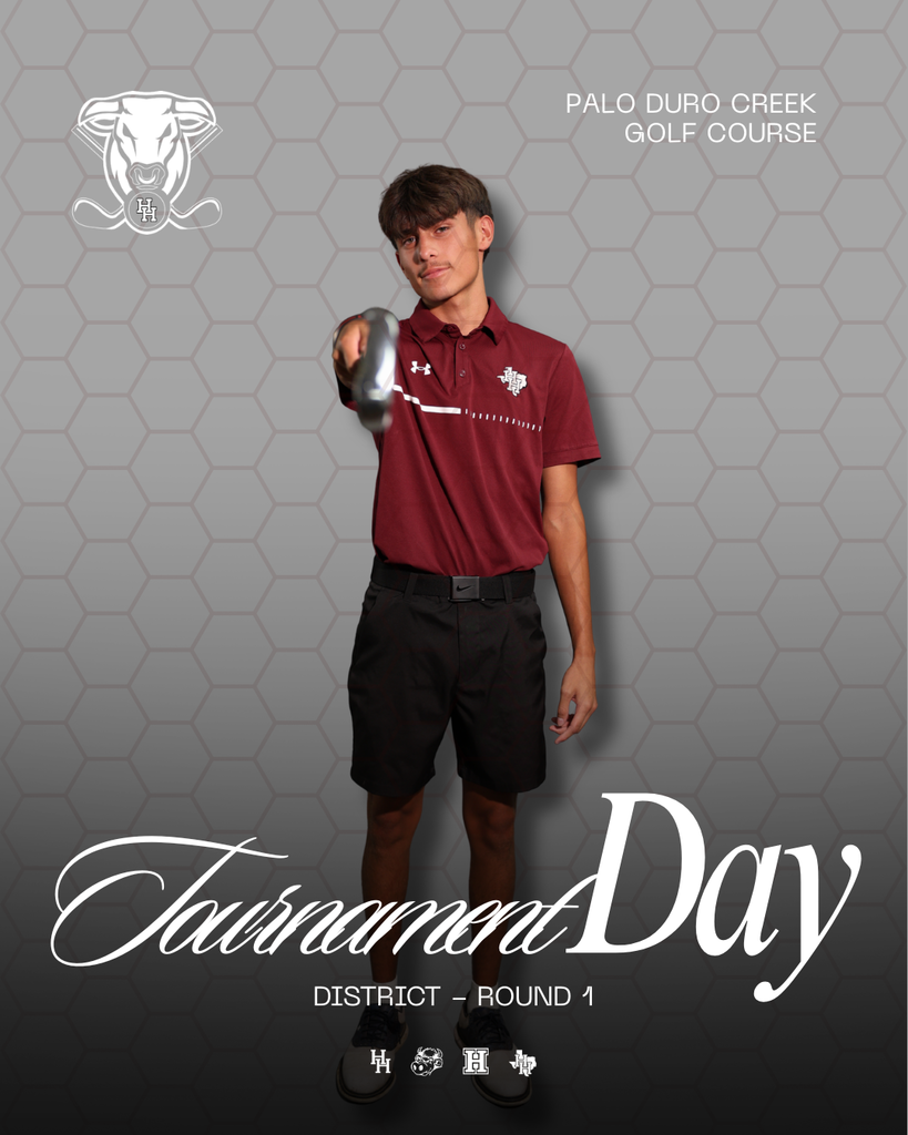 A man in a maroon shirt and black shorts poses for a photo at a golf course.