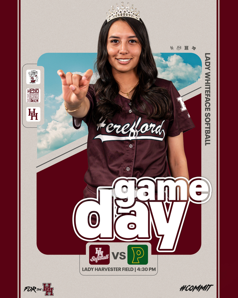 A smiling woman in a maroon shirt and crown poses for a photo at a sports event.