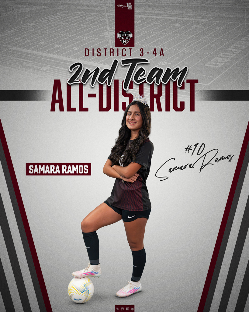 A woman, wearing a soccer uniform, poses with a soccer ball in front of a blurred sports field background.