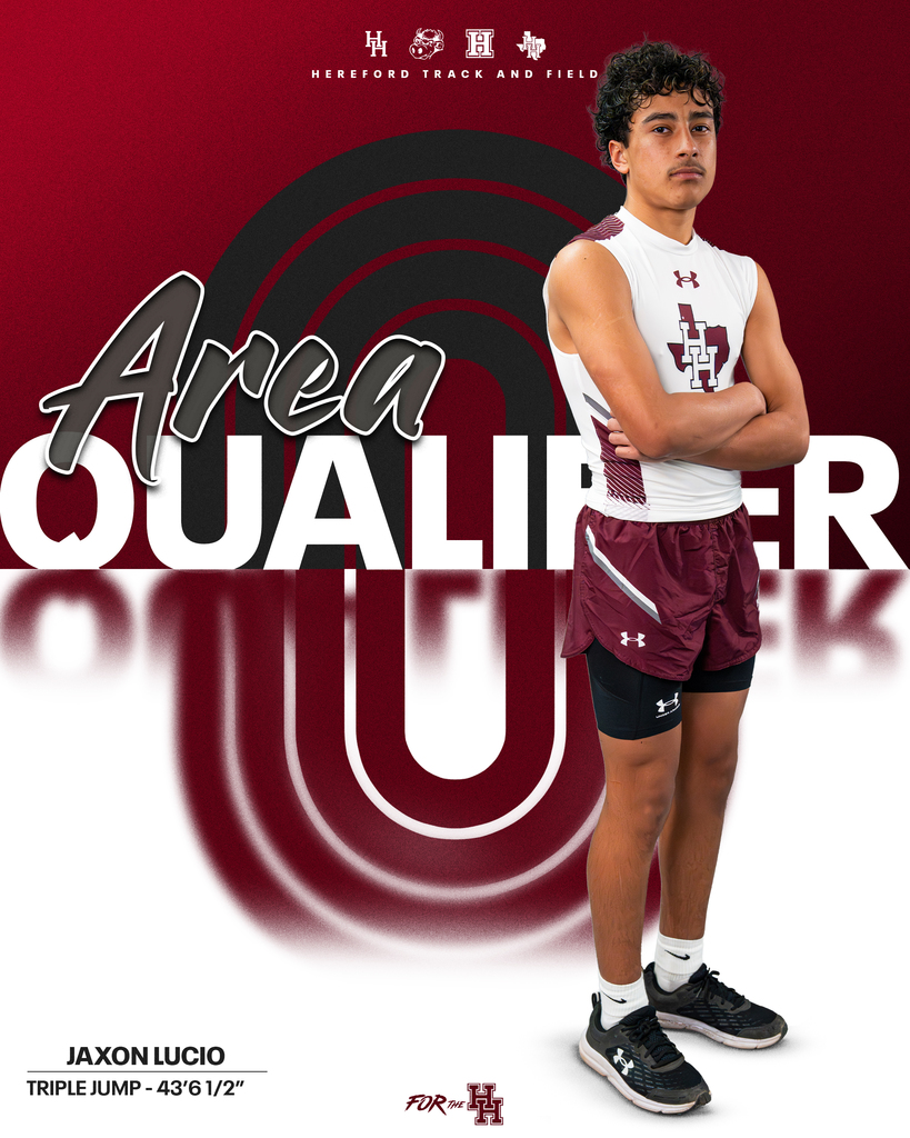 A man stands with arms crossed, wearing a maroon and white athletic uniform. Behind him is a red and white background.