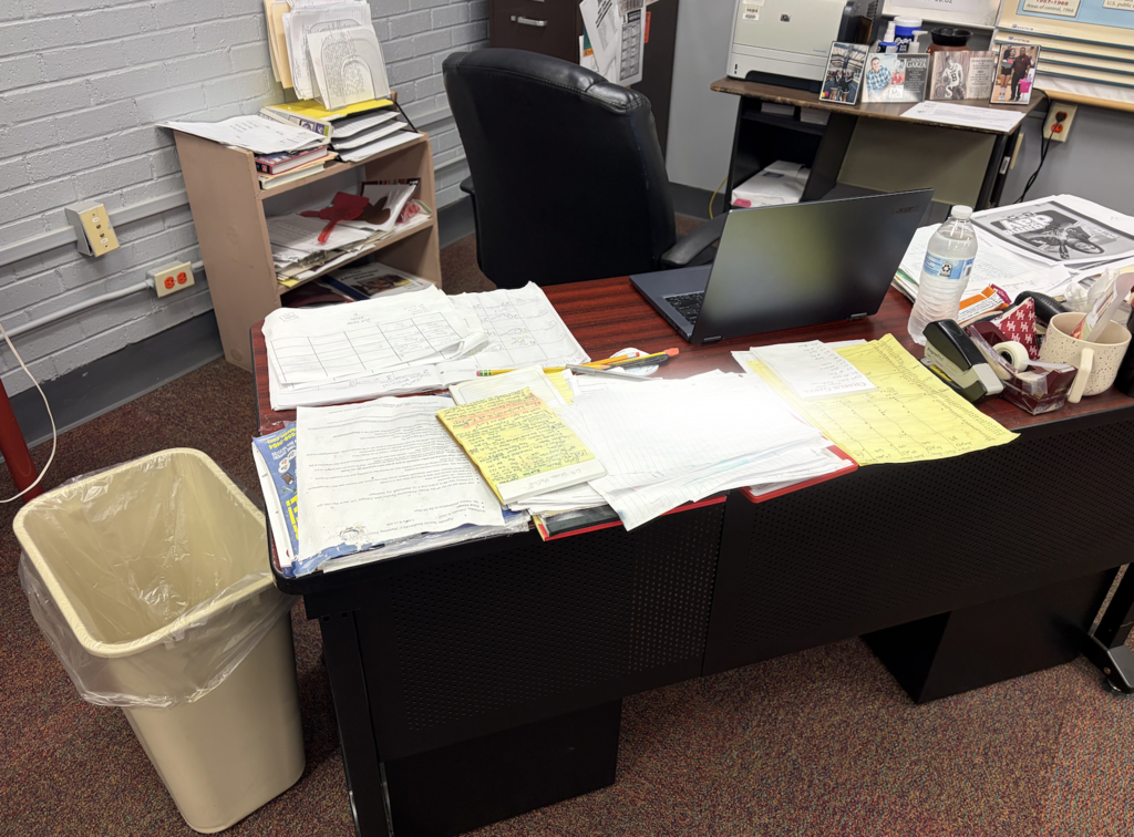 ruined papers on a teachers desk due to water damage