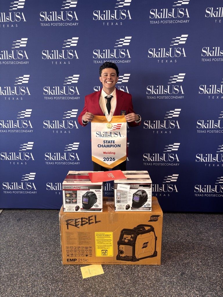 Person wearing a red suit with a tie stands in front of a SkillUSA banner. Holds a certificate and a yellow ribbon.