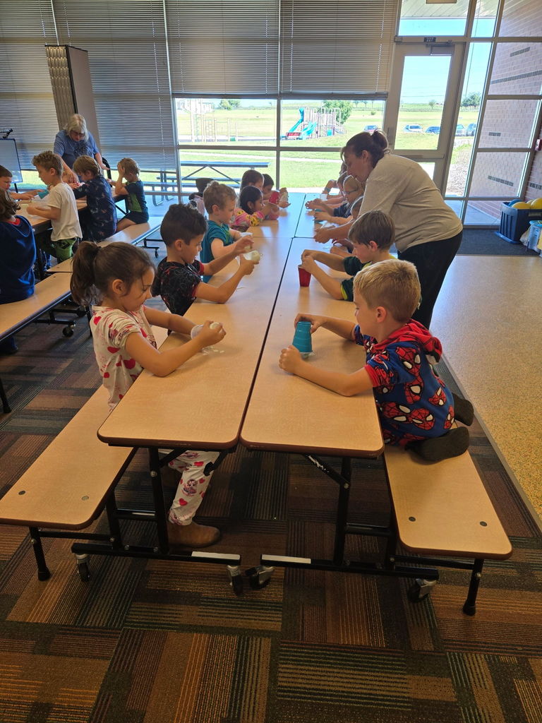 Second graders experiment with oobleck which can be both a solid and a liquid.
