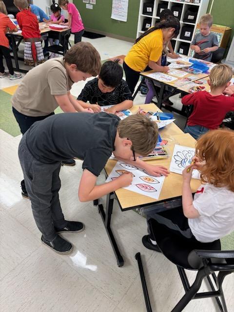 Second graders helping kindergarteners