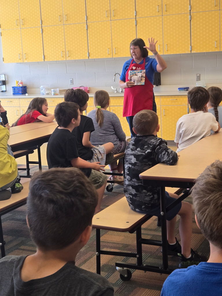 Ms. Susan sharing a book about lambs