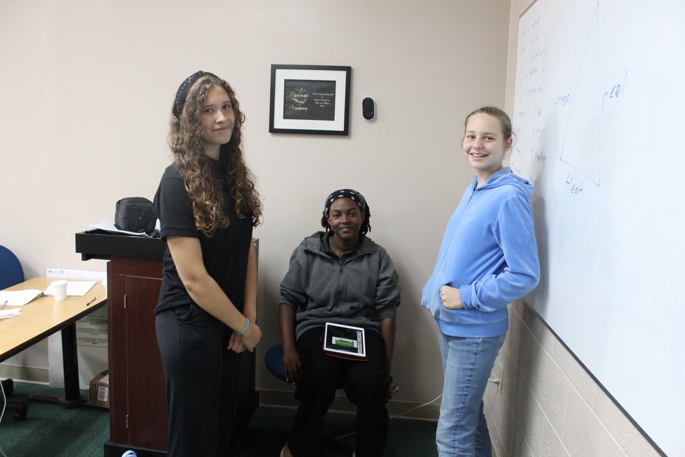 3 teen gilrs in a classroom