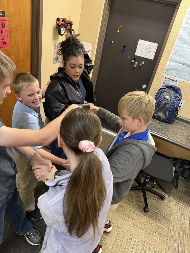 Elementary students hold hands