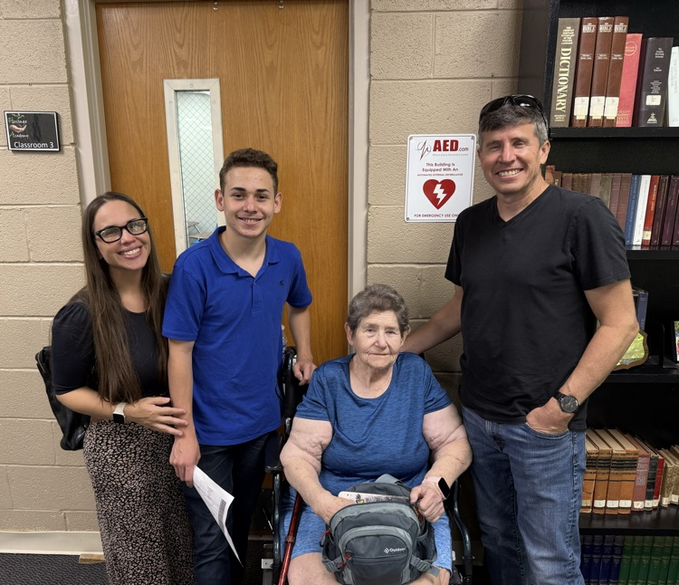 family with elderly grandmother sitting down