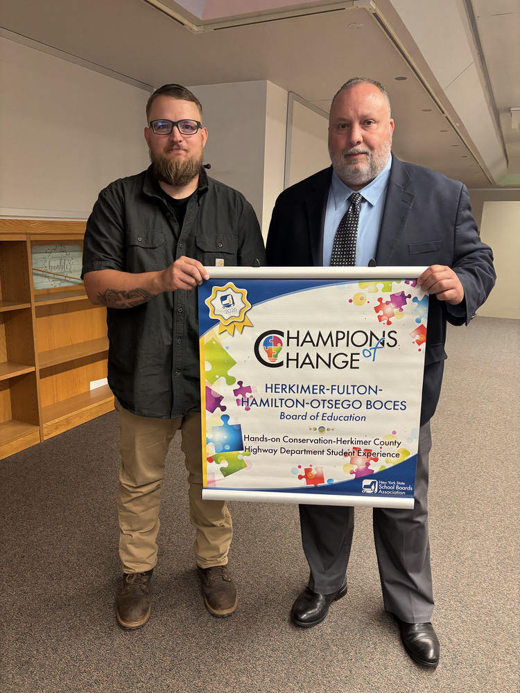 William Carpenter and James Garcia holding Champions of Change award banner