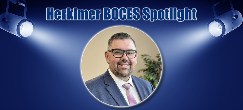 Nicholas Devins with the words "Herkimer BOCES Spotlight" and spotlight images shinining on him