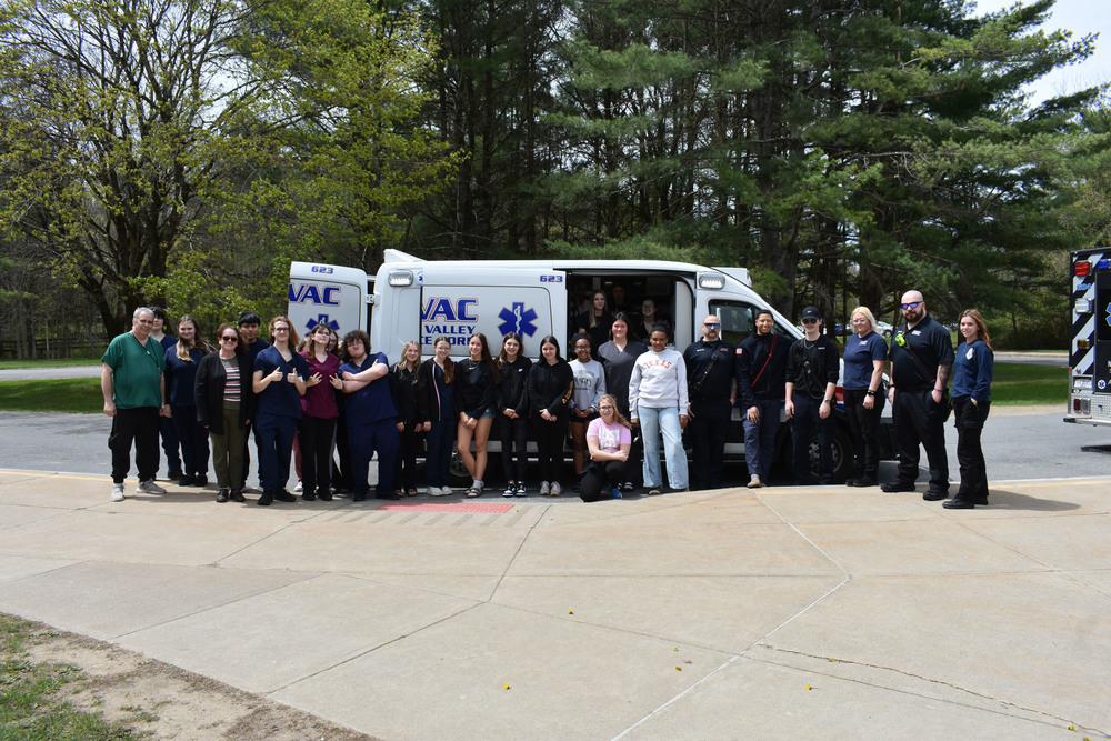 Health Science Careers students, Criminal Justice students, Health Science teachers and MOVAC employees pose by ambulance outside