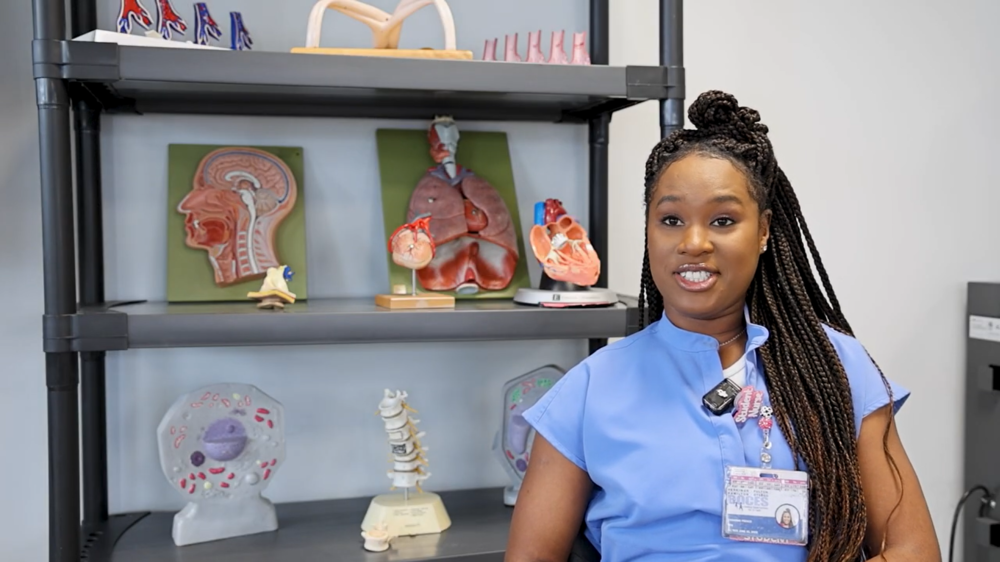 Adult LPN student speaking in front of display case