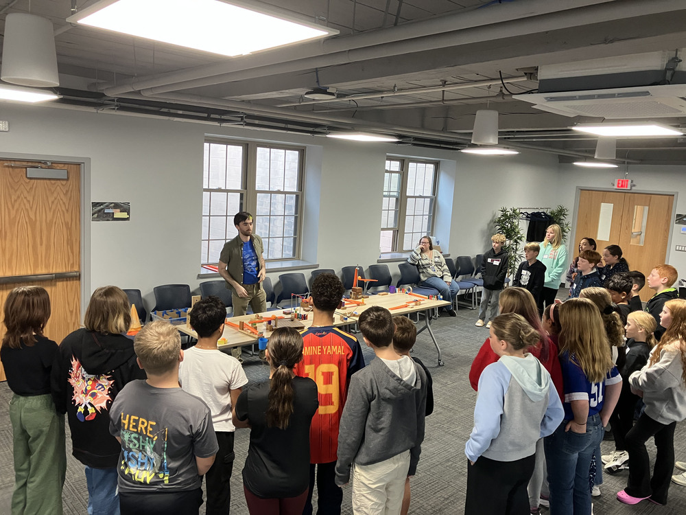 Sixth graders look on as Merlin Katz from Playful Engineers presents to them