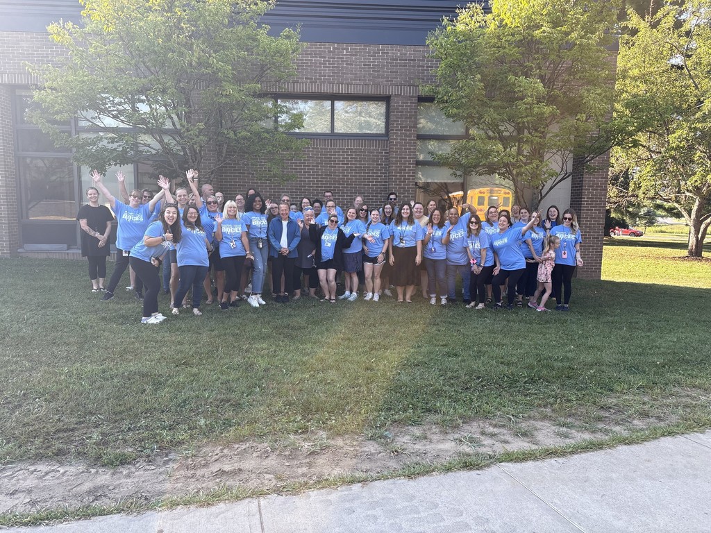 Many staff members pose outside BOCES building on grass